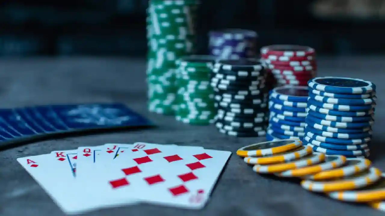 Casino table set up for a game of poker, with chips and cards ready to play.