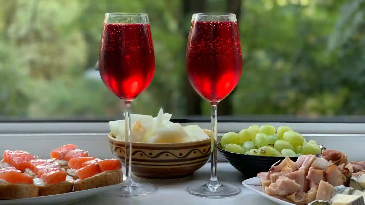 Two wine glasses with red Greek wine on a table pairing Greek cuisine food