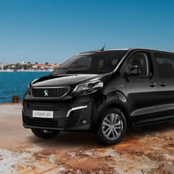 Black Peugeot Traveller minivan parked by water