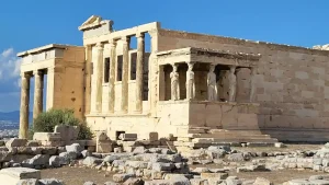 The Erechtheion, a historic temple on the Acropolis in Athens, Greece. The temple features iconic Caryatid statues, which are female figures supporting the roof.