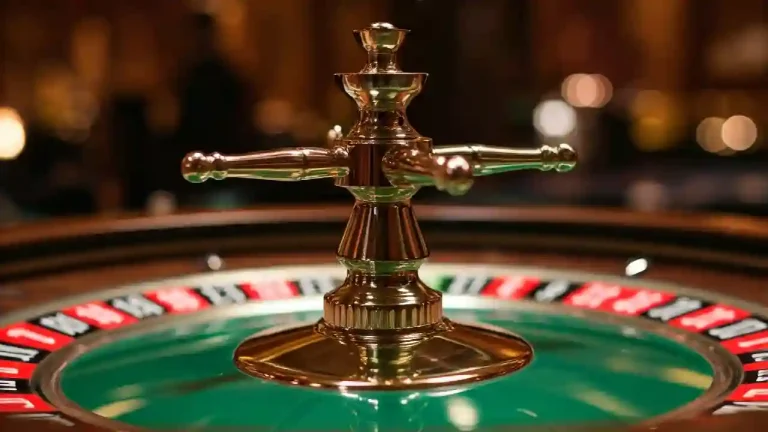 A close-up view of a spinning roulette wheel in a casino. The wheel is green with numbered slots, and a small white ball is moving around the edge.