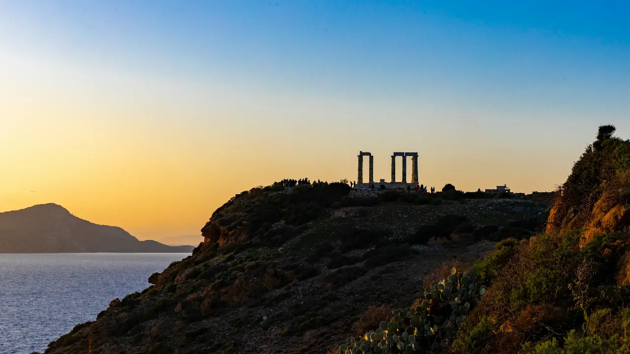 A beautiful view of Greece in 2025 with blue waters and ancient ruins.