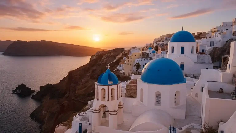 Greek Islands in Winter with Santorini’s blue-domed churches and whitewashed houses glowing under a golden sunset.